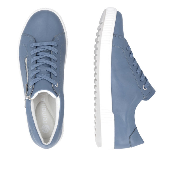 Blue sneakers with white soles on a white background