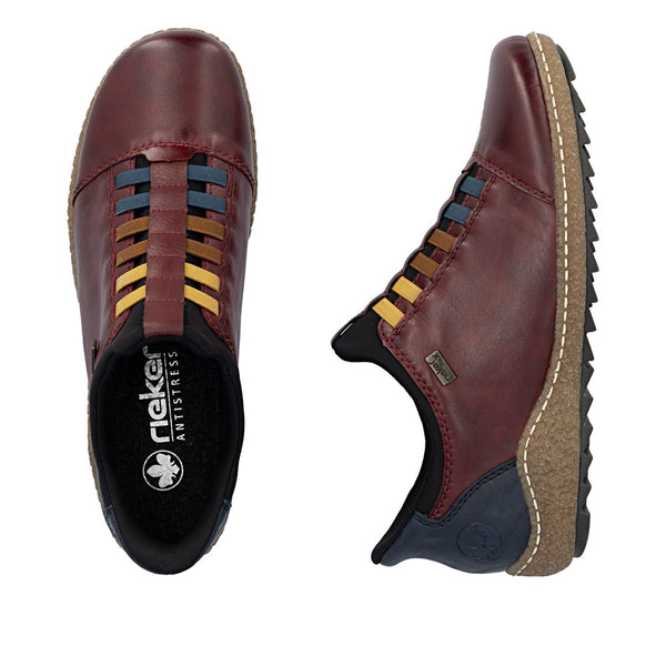 Burgundy shoes with colorful laces on a white background