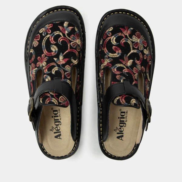Pair of black clogs with floral embroidery on a white background