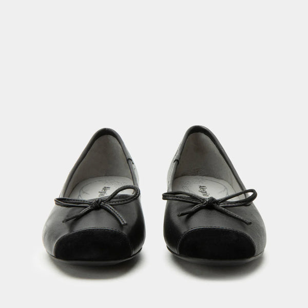 Pair of black shoes with a bow on a white background