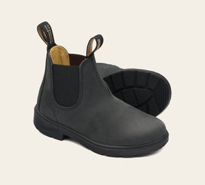 A pair of kids' Blundstone boots in rustic black color, featuring a slip-on design with elastic side panels, a round toe, and a flat polyurethane sole.