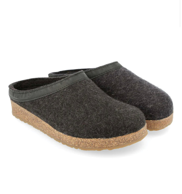 A pair of Haflinger GZL charcoal-colored slip-on clogs with a wool felt upper and a cork and latex midsole.